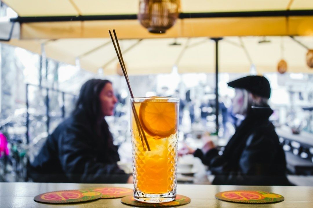 Alkoholfri orange drink med apelsinskiva på ett cafébord